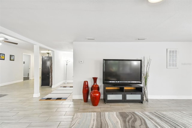 living room with light hardwood / wood-style floors and ceiling fan