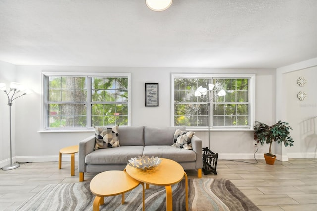 living room featuring a textured ceiling and light hardwood / wood-style floors