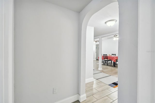 3419 19th St E, Bradenton, FL 34208 - hallway with light wood-style flooring, baseboards, and arched walkways