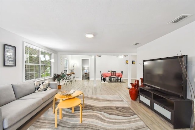 living room with vaulted ceiling and light hardwood / wood-style flooring