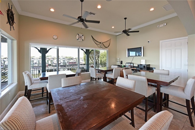 tiled dining room featuring ceiling fan and crown molding