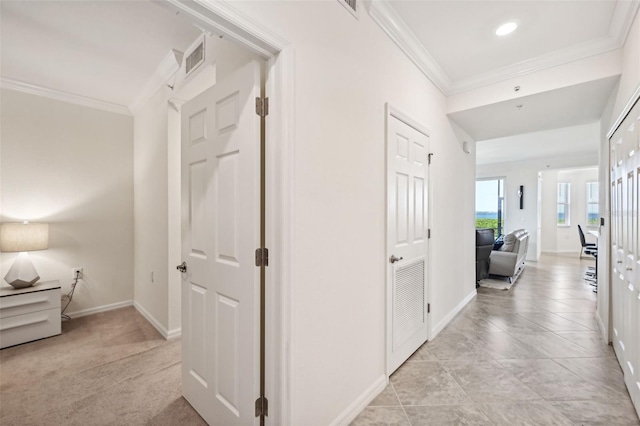 hall with light colored carpet and ornamental molding