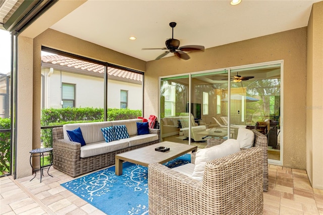 sunroom / solarium featuring a healthy amount of sunlight and ceiling fan