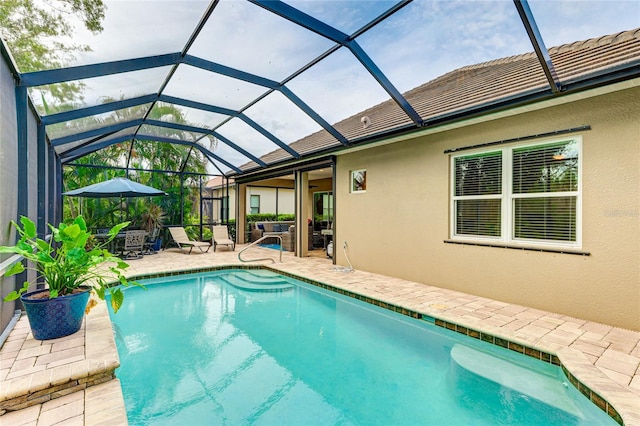 view of pool featuring outdoor lounge area, a lanai, and a patio area