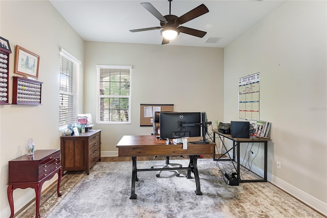 office space with light wood-type flooring and ceiling fan