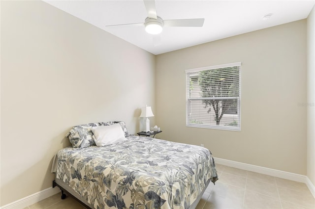 tiled bedroom featuring ceiling fan