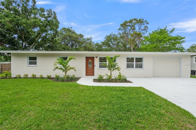 single story home with a garage and a front lawn