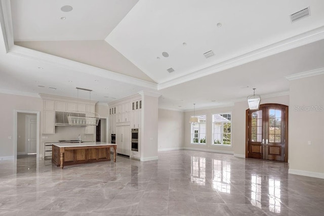 unfurnished living room featuring ornamental molding, french doors, and high vaulted ceiling