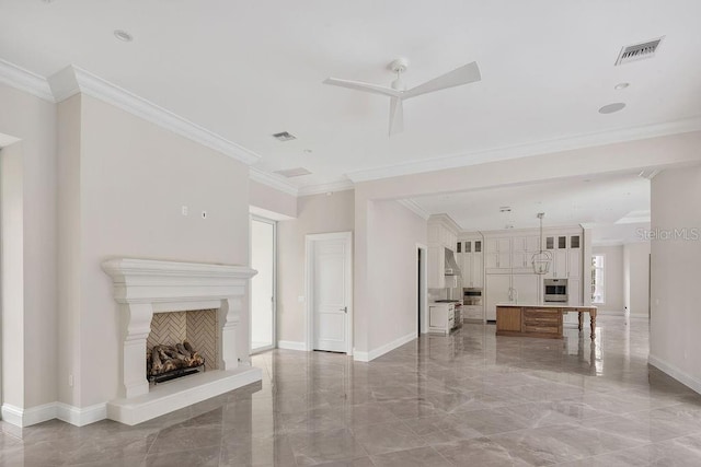 unfurnished living room with crown molding, ceiling fan, and a wealth of natural light