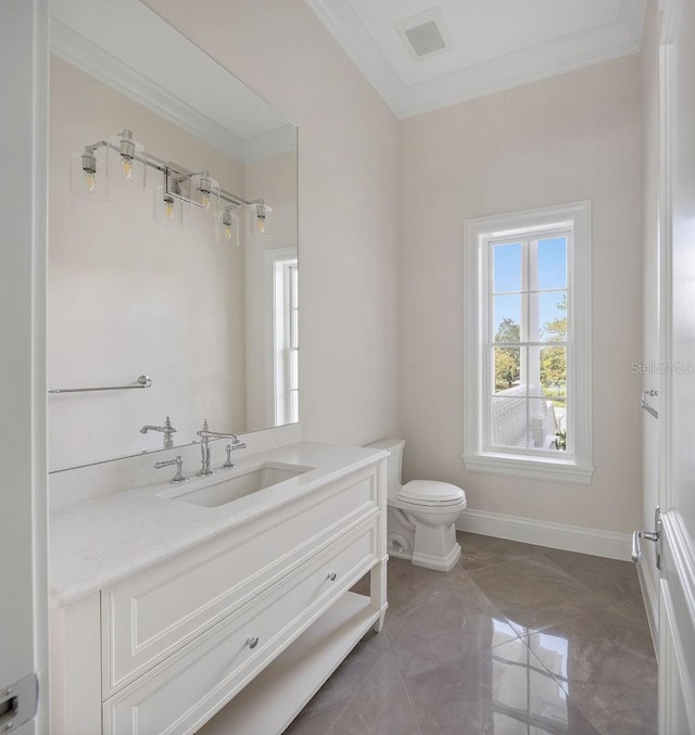 bathroom with vanity, crown molding, and toilet