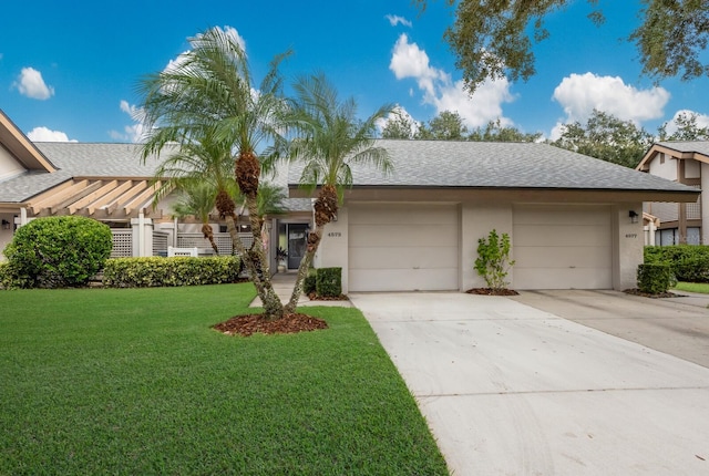 view of front of property featuring a garage and a front lawn