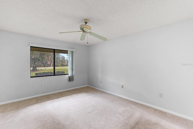 carpeted empty room featuring a textured ceiling and ceiling fan