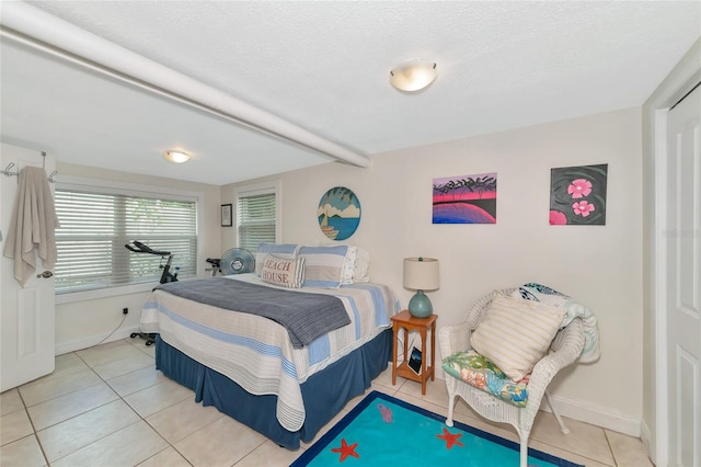 tiled bedroom featuring a textured ceiling