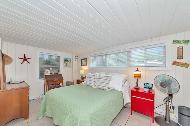 tiled bedroom with multiple windows