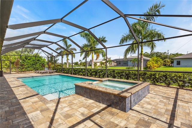 view of pool with a lanai, an in ground hot tub, and a patio area