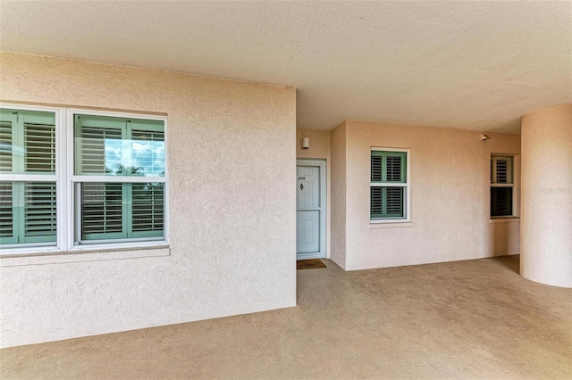 doorway to property with stucco siding