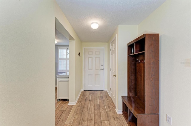 interior space with light hardwood / wood-style flooring and a textured ceiling