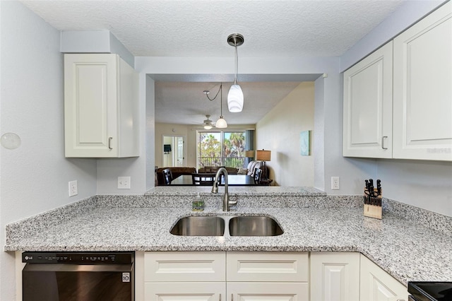 kitchen with a textured ceiling, white cabinets, dishwasher, a sink, and light stone counters