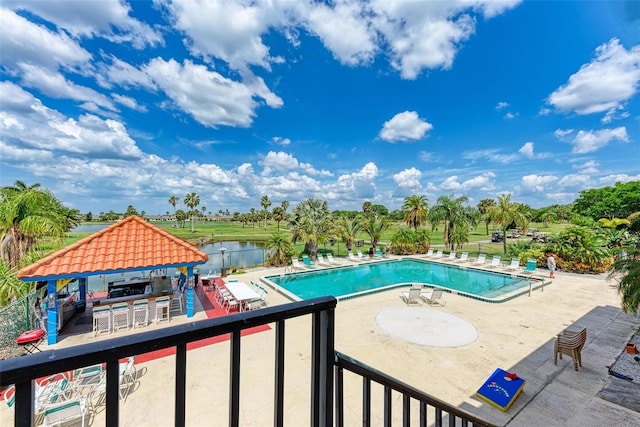 view of swimming pool with a patio, a water view, and a gazebo