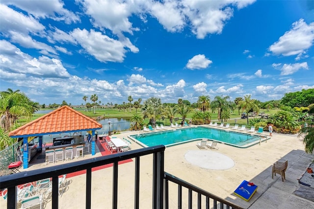 community pool with a gazebo and a patio