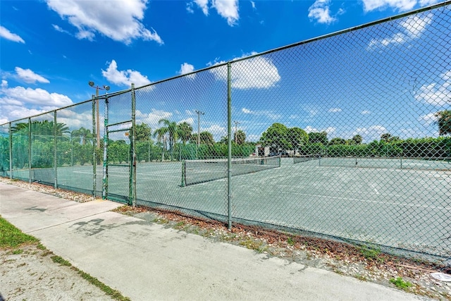 view of sport court featuring fence