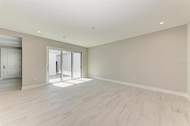 spare room featuring light hardwood / wood-style flooring