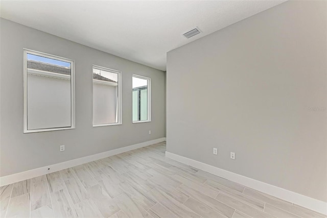 spare room featuring light wood-type flooring