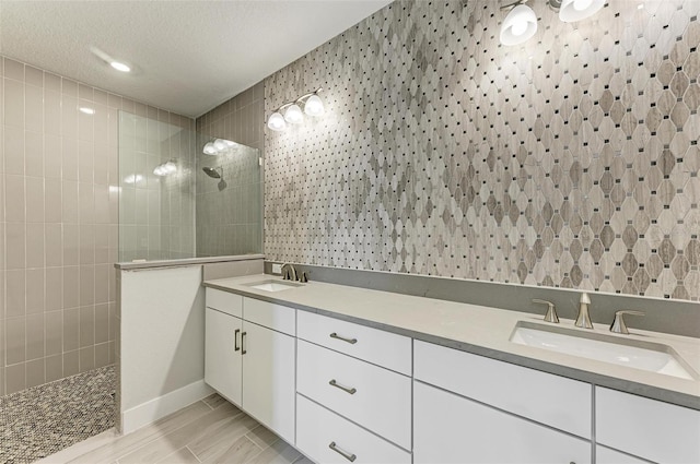 bathroom with a textured ceiling, a shower, vanity, and hardwood / wood-style floors