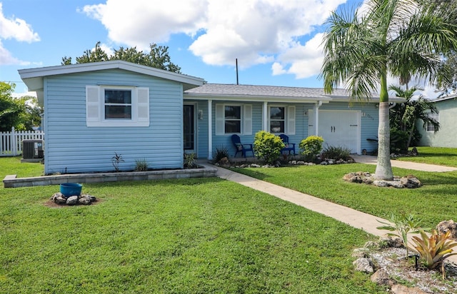 view of front of home featuring a front yard, a porch, and central AC