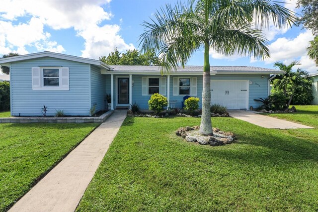 22119 Laramore Ave, Port Charlotte, FL 33952 - single story home with driveway, a front yard, and a garage