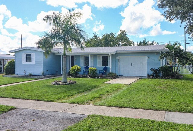 22119 Laramore Ave, Port Charlotte, FL 33952 - ranch-style house with driveway, an attached garage, and a front lawn