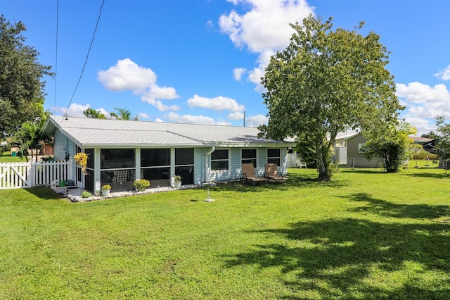 22119 Laramore Ave, Port Charlotte, FL 33952 - back of property with a lawn, a sunroom, and fence