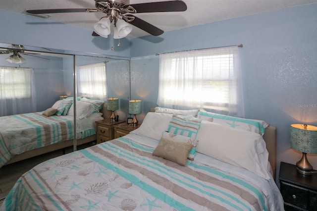 bedroom featuring ceiling fan and a closet