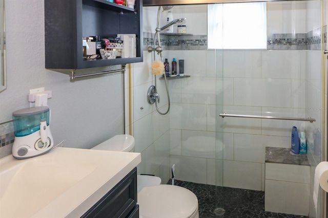 bathroom with walk in shower, vanity, and toilet