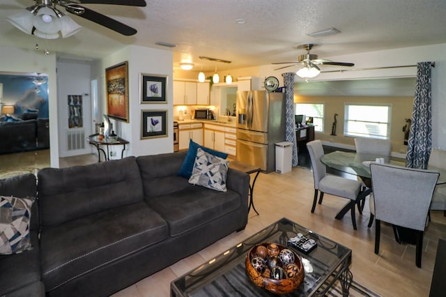 22119 Laramore Ave, Port Charlotte, FL 33952 - living area with ceiling fan and a textured ceiling