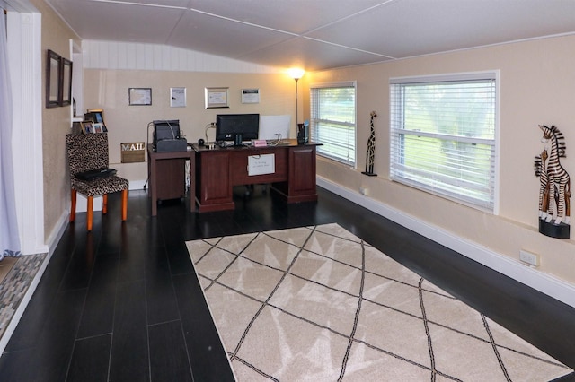 home office featuring dark hardwood / wood-style floors and vaulted ceiling