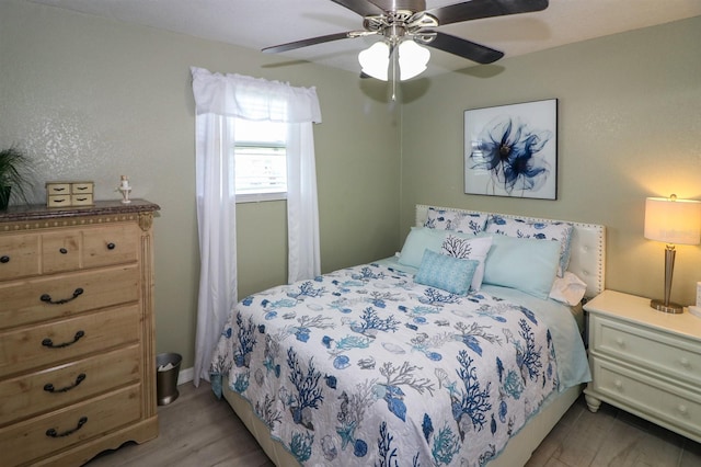 bedroom featuring light hardwood / wood-style floors and ceiling fan