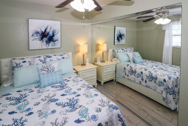 bedroom featuring ceiling fan, hardwood / wood-style flooring, and a closet