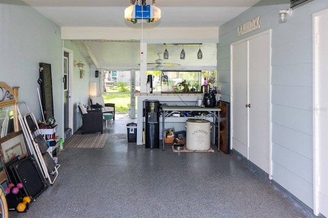 garage with a garage door opener and ceiling fan