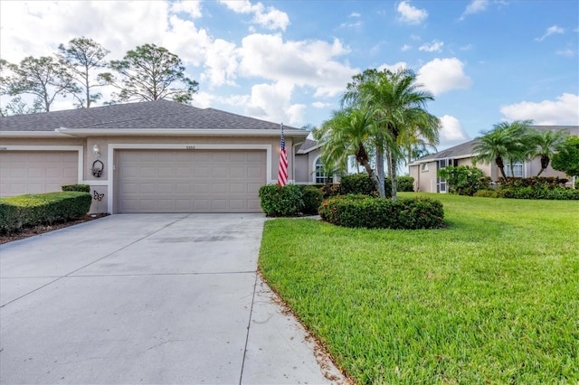 5092 Mahogany Run Ave, Sarasota, FL 34241 - ranch-style home featuring driveway, a garage, a front yard, and stucco siding