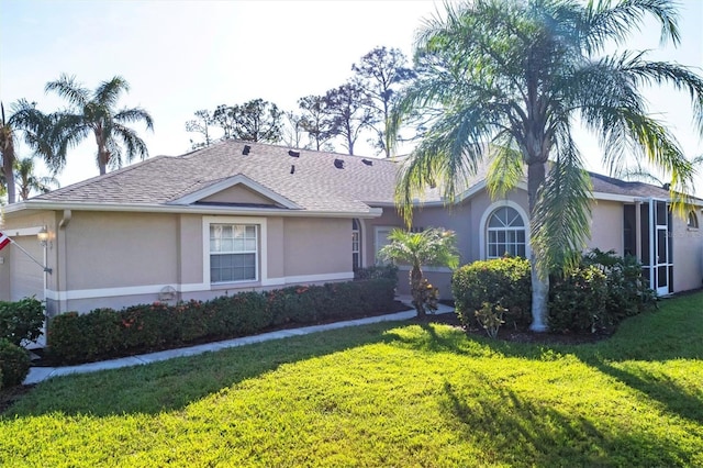 5092 Mahogany Run Ave, Sarasota, FL 34241 - view of front facade with stucco siding and a front lawn
