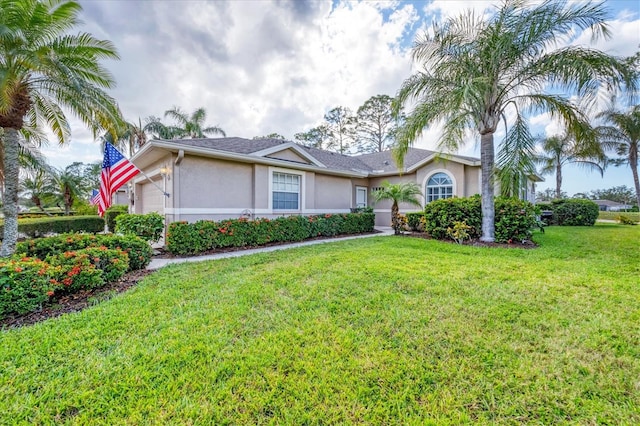 ranch-style home with a garage and a front lawn