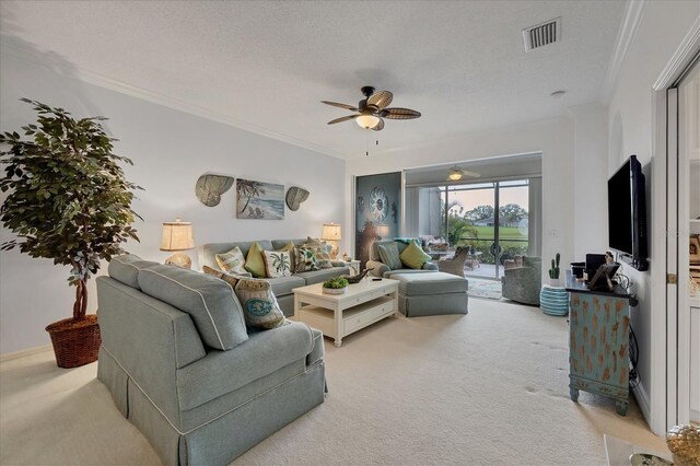 carpeted living room with crown molding, a textured ceiling, and ceiling fan