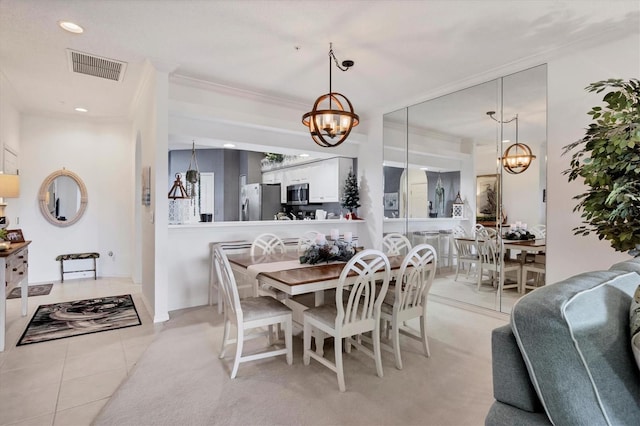 tiled dining area featuring a notable chandelier and crown molding