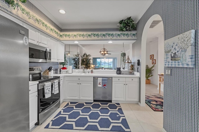 5092 Mahogany Run Ave, Sarasota, FL 34241 - kitchen featuring appliances with stainless steel finishes, light countertops, white cabinets, light tile patterned floors, and crown molding