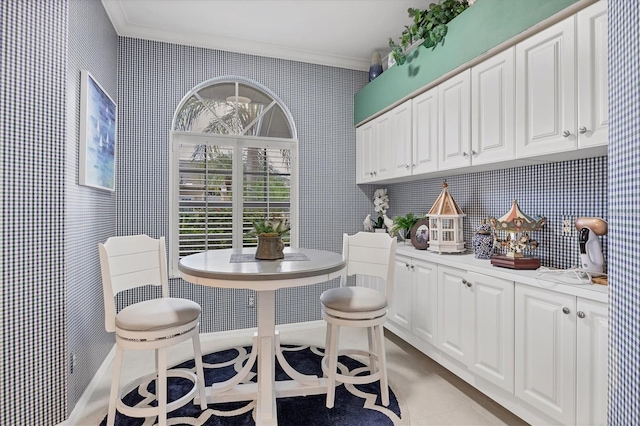 5092 Mahogany Run Ave, Sarasota, FL 34241 - dining space featuring crown molding, wallpapered walls, and light tile patterned floors