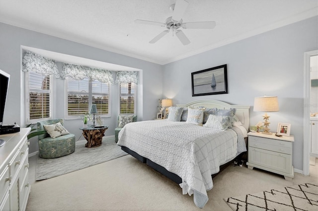 carpeted bedroom featuring ceiling fan and crown molding