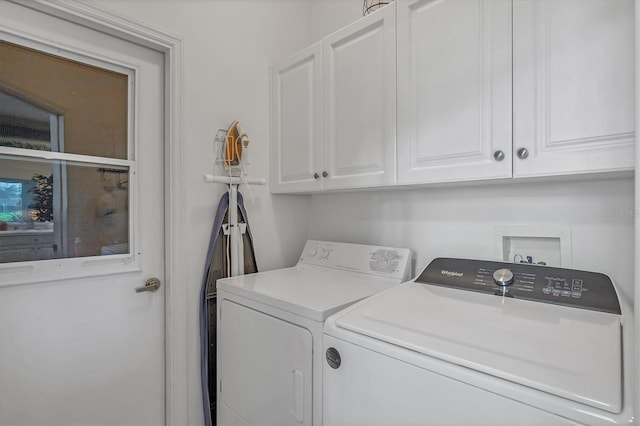 washroom with cabinets and separate washer and dryer