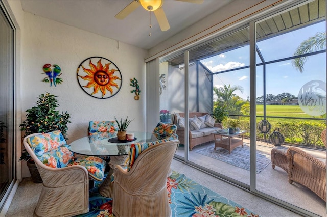 sunroom featuring ceiling fan