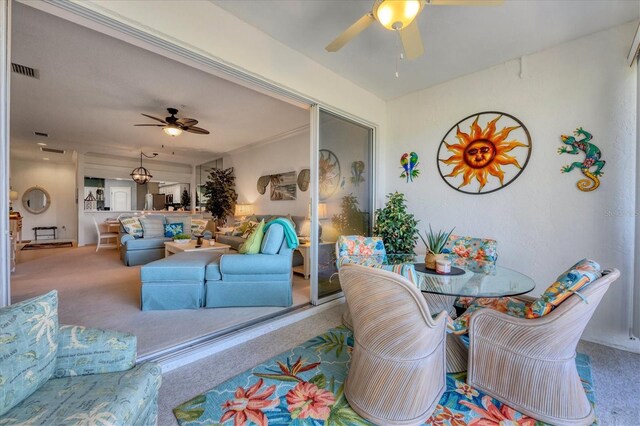 dining room featuring carpet flooring and ceiling fan